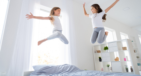 children jumping on the bed